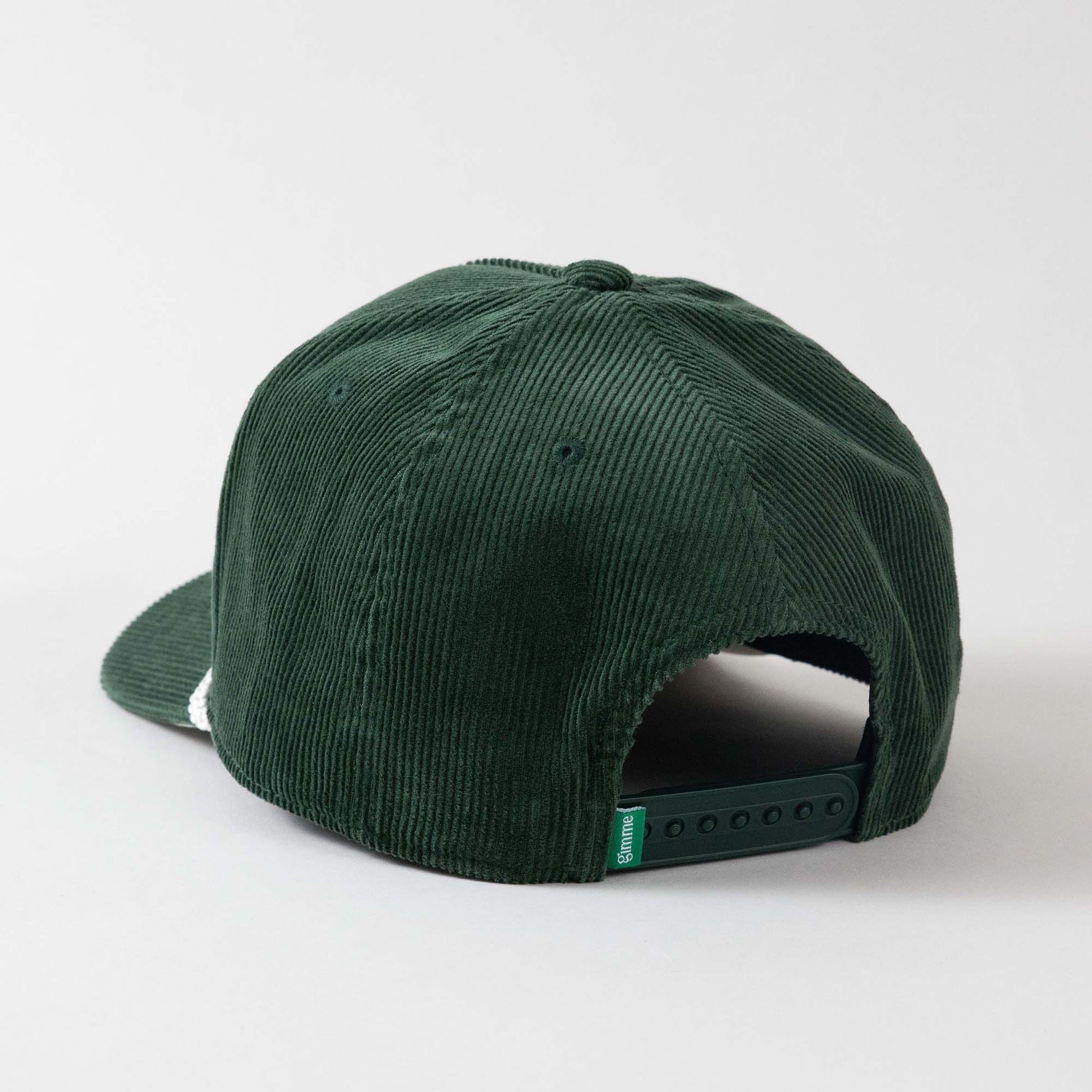 Backside view of The Gimme Tour Corduroy snapback golf cap, showing back details such as a gimme labeled patch and size adjustment – A Sort of Golf Company.