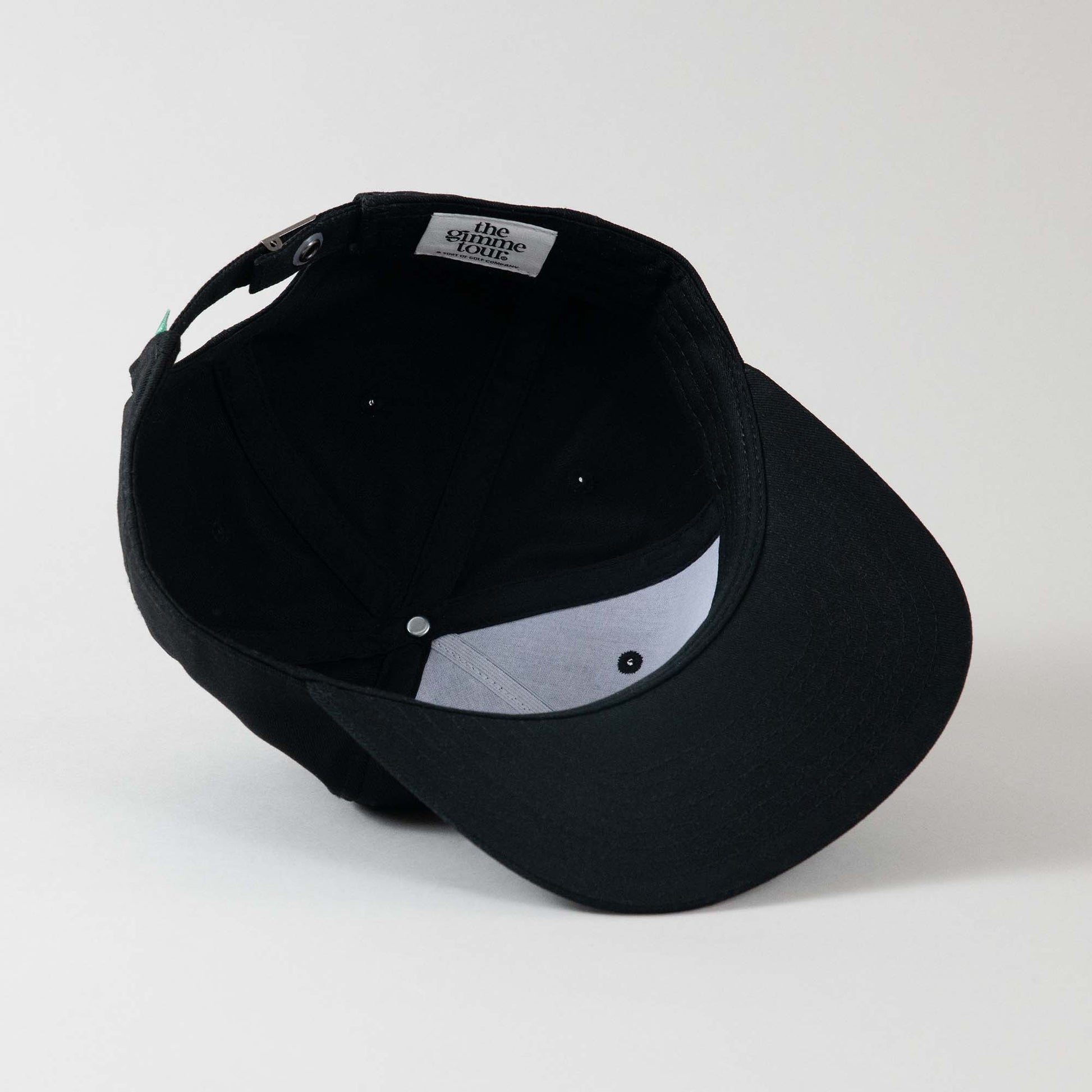 Underside view of The Gimme Tour Gimme Deadstock adjustable cap, showing inner details and branded taping – A Sort of Golf Company.