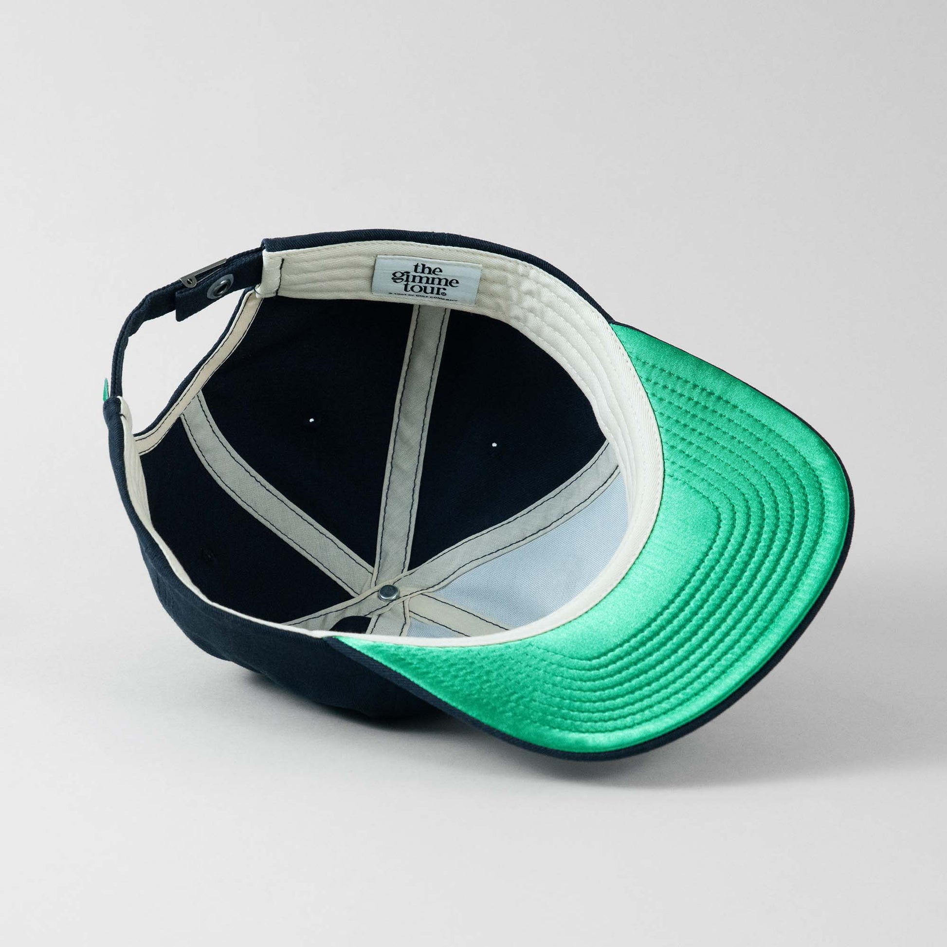 Underside view of The Gimme Tour vintage felt adjustable cap, showing inner details and branded taping – A Sort of Golf Company.